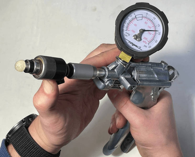 Testing fuel injector using a vacuum pump